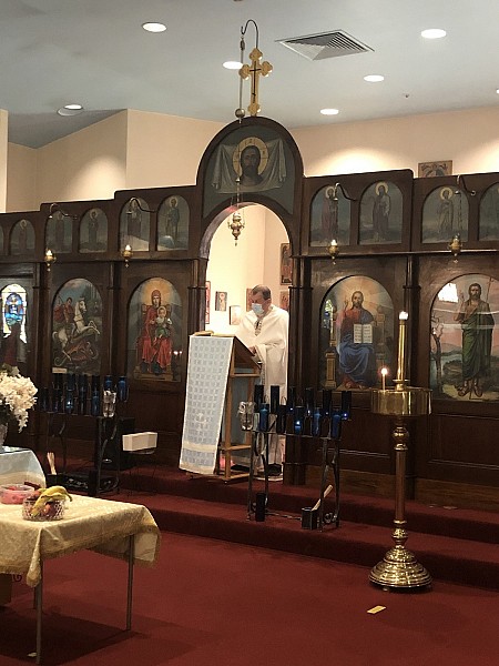 Fr. Sergei reading the daily Gospel lesson