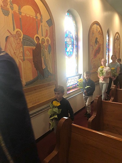 After Divine Liturgy, in procession with the Cross, followed by the parish children carrying flowers