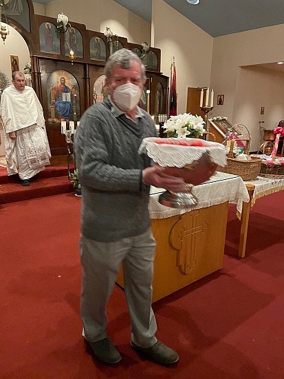 Bob Lazar brings the Paschal Eggs to the rear of the church to be handed out to parishioners