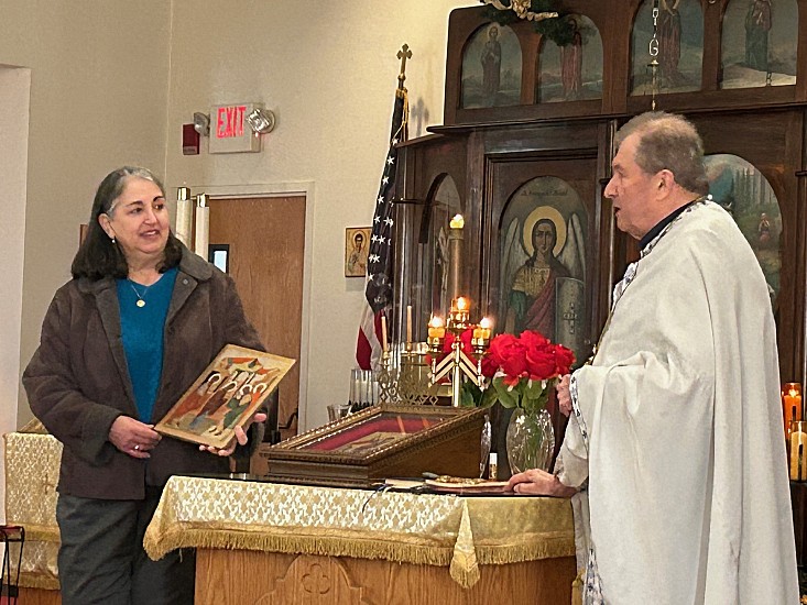 Diane Cryan, President of the Teuta Society, receives the icon of the Meeting of Our Lord in the Temple, the Patronal Feast for the Ladies Society, as part of the parish's celebration of the Albanian tradition of 